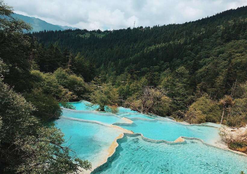 Huanglong Scenic Area: Explore Stunning Five-Colored Ponds - Primeval forest time, when the air and footing slow you down