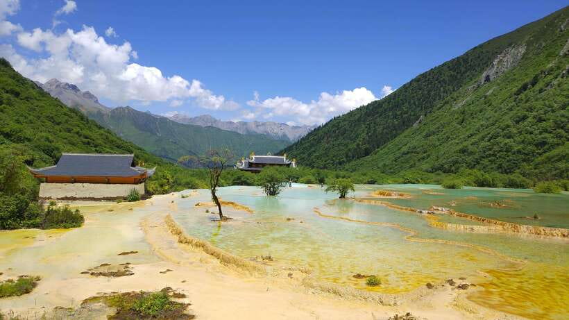Huanglong Scenic Area: Explore Stunning Five-Colored Ponds - Moving through the park, cable car plus optional shuttle